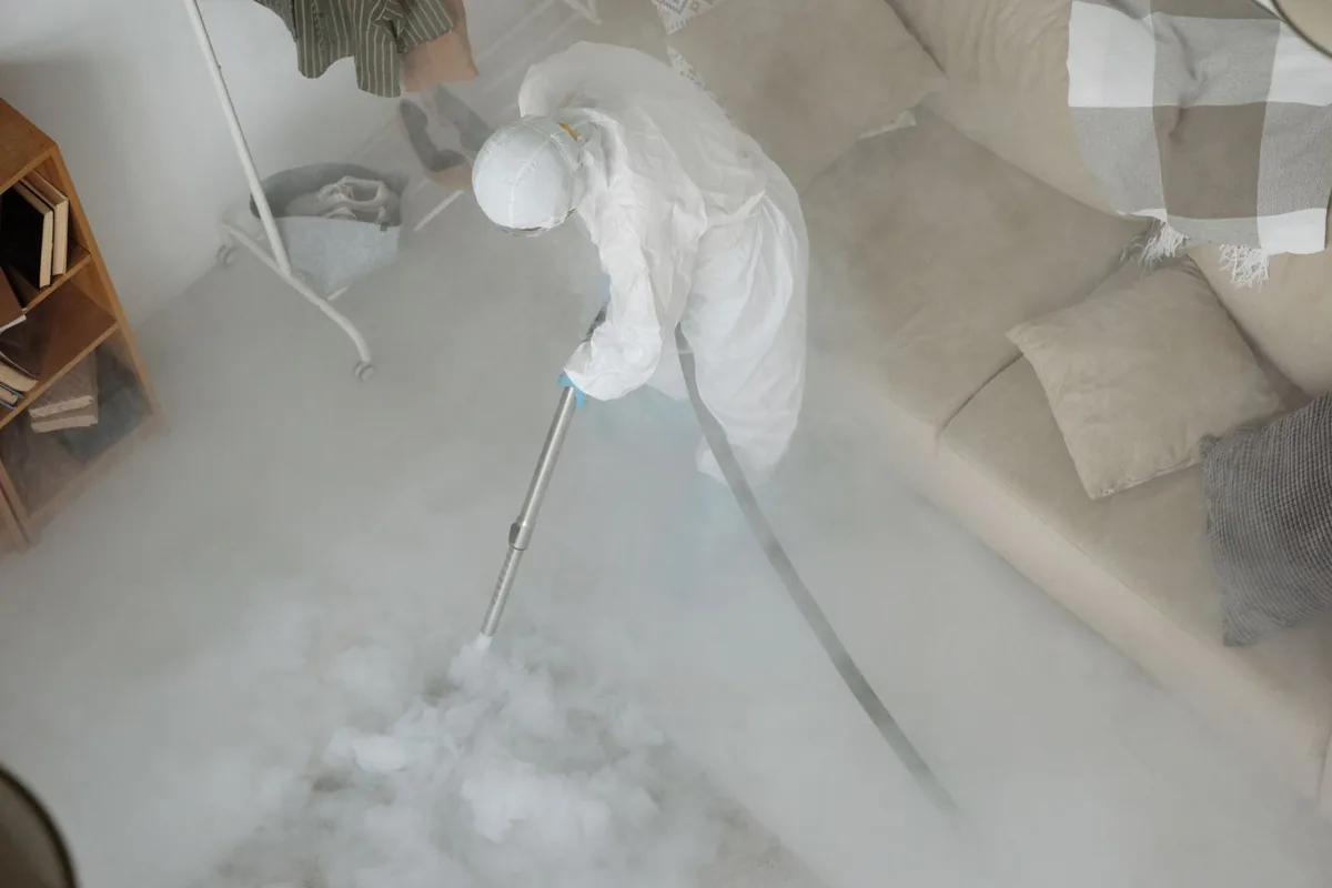 Biohazard cleanup technician in protective equipment, Van Buren, ME
